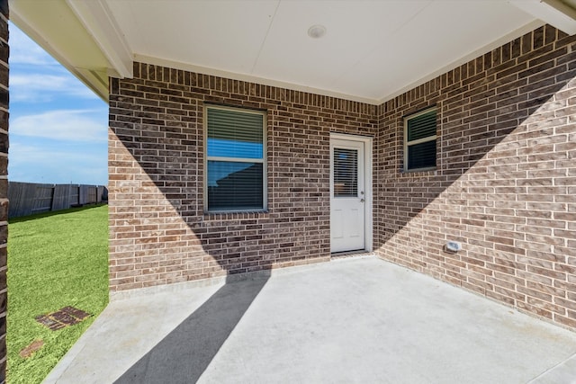 property entrance with a yard and a patio area