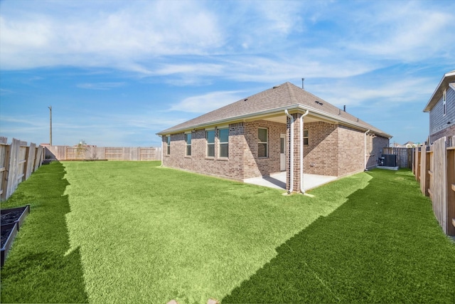 back of property featuring a lawn, a patio area, and central air condition unit