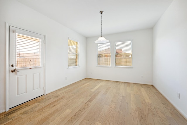 unfurnished dining area featuring plenty of natural light and light wood-type flooring