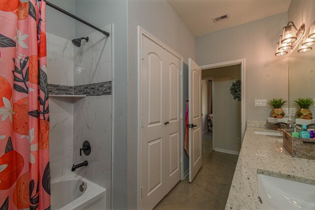 bathroom featuring concrete flooring, vanity, and shower / tub combo