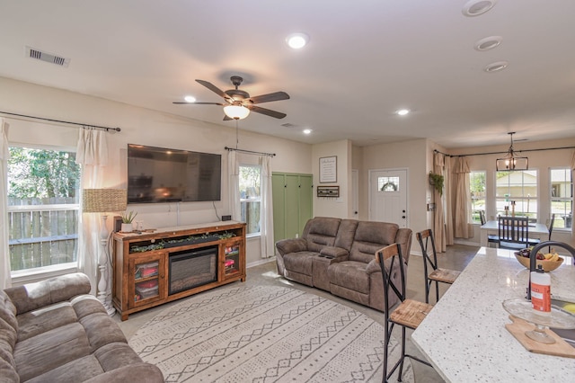 living room with a wealth of natural light and ceiling fan