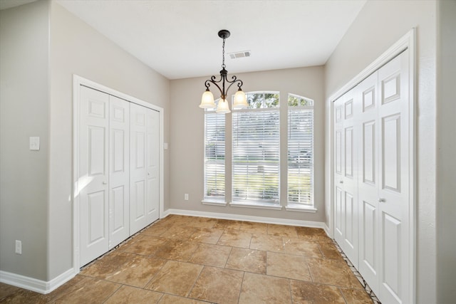 unfurnished dining area featuring a chandelier and a wealth of natural light