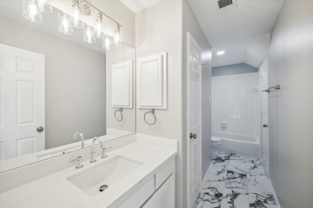 full bathroom with vanity, tiled shower / bath combo, and toilet