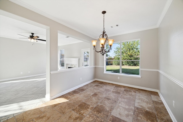 unfurnished dining area featuring ceiling fan with notable chandelier and crown molding