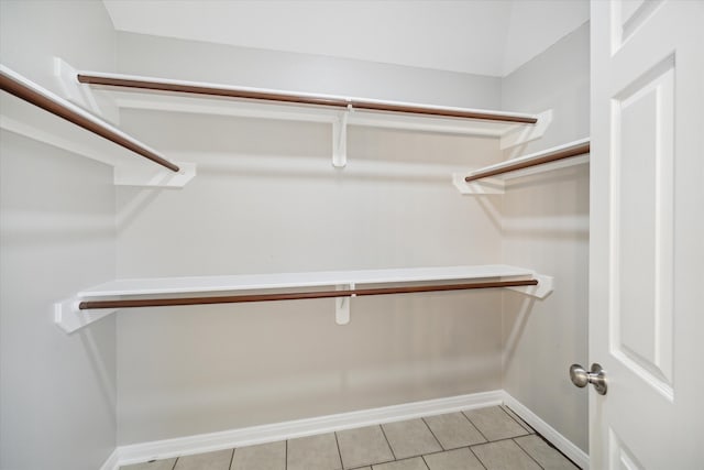 spacious closet with light tile patterned floors