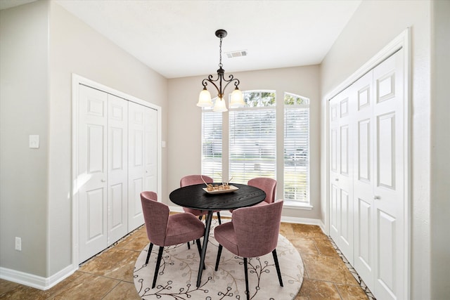 dining space featuring a notable chandelier