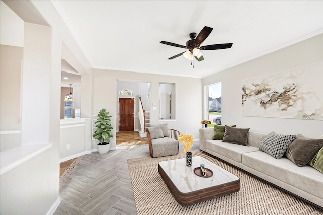 living room with ceiling fan, ornamental molding, and parquet floors