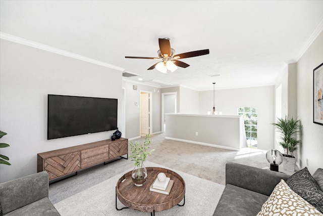 carpeted living room with ornamental molding and ceiling fan