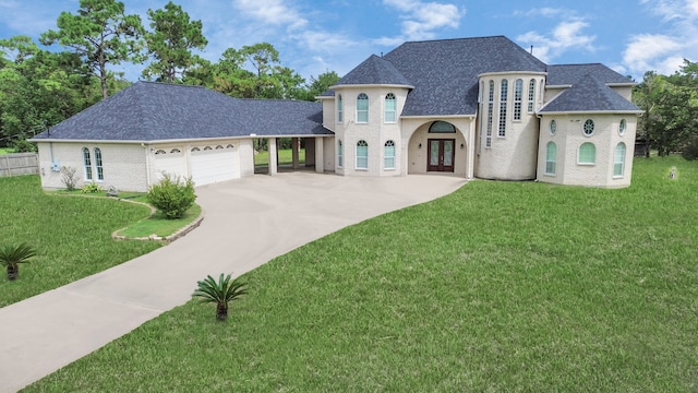 french country style house with a garage and a front lawn