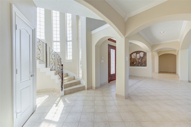 entryway featuring crown molding and light tile patterned floors