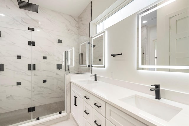 bathroom with vanity and a shower with shower door