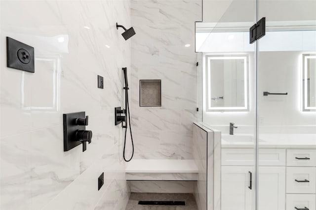 bathroom with sink and tiled shower