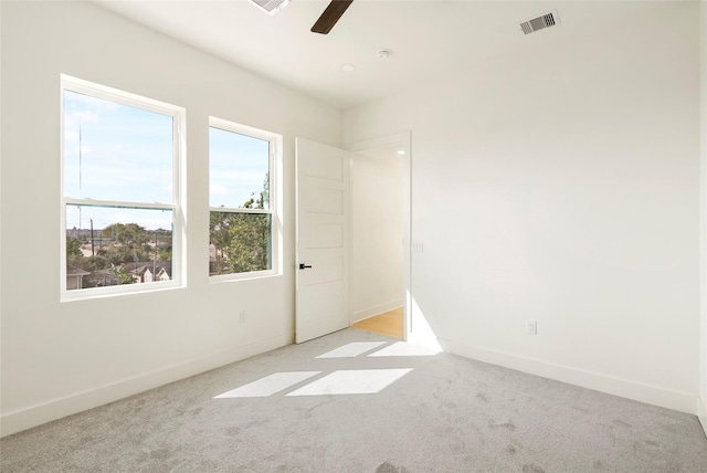 carpeted empty room featuring ceiling fan