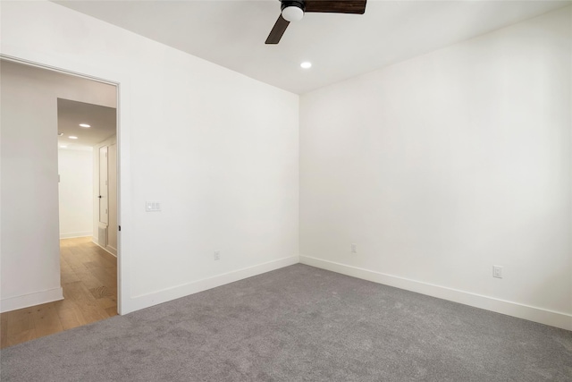 empty room with ceiling fan and carpet