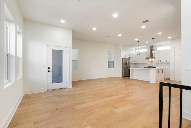 unfurnished living room featuring light hardwood / wood-style floors