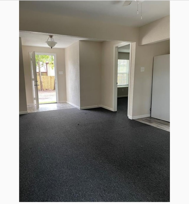 spare room with ceiling fan and carpet floors