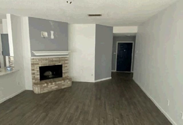 7432 Ashbourne Way, Fort Worth, TX 76133 - unfurnished living room with wood finished floors, a fireplace, and baseboards