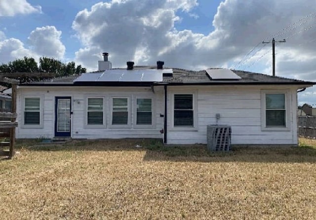 7432 Ashbourne Way, Fort Worth, TX 76133 - rear view of property with solar panels, central AC, a lawn, and a chimney