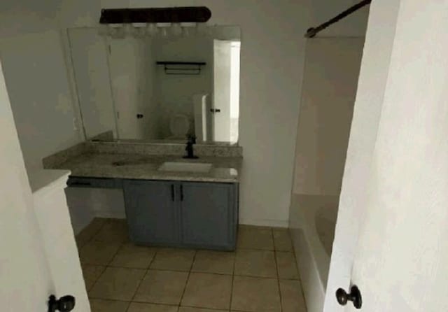 full bathroom featuring  shower combination, tile patterned floors, and vanity