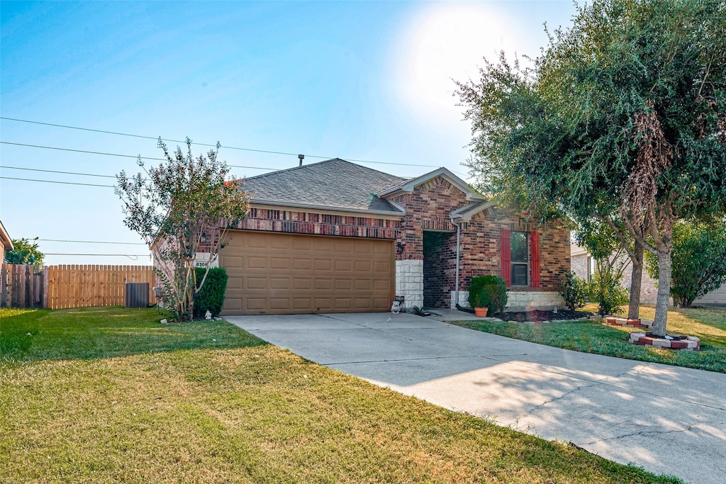 ranch-style house featuring a garage and a front yard