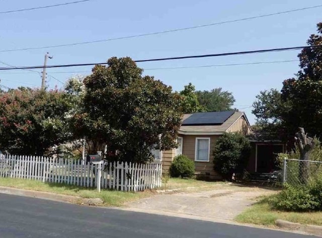 view of front facade featuring solar panels