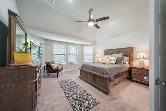 bedroom with ceiling fan, light colored carpet, lofted ceiling, and multiple windows