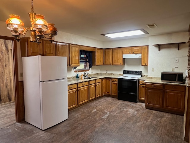 kitchen featuring light stone countertops, dark wood-type flooring, white appliances, sink, and hanging light fixtures