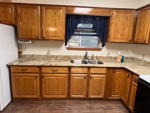 kitchen with light stone countertops, sink, dark hardwood / wood-style flooring, white fridge, and black range with electric stovetop