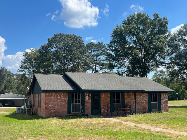 single story home with central AC and a front yard