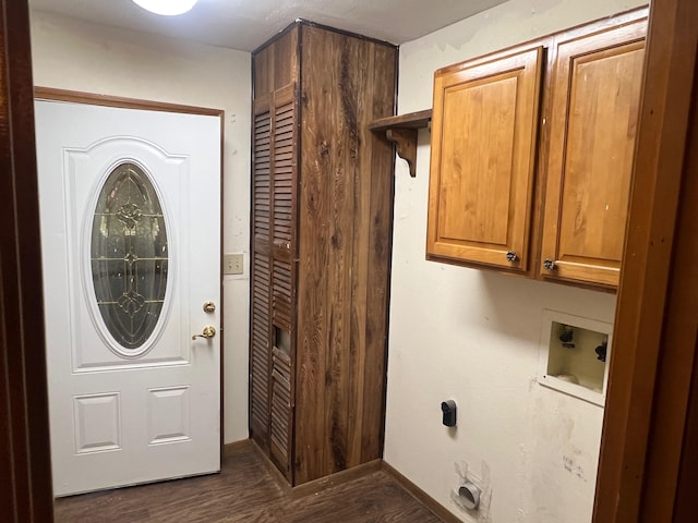 laundry area with hookup for a washing machine, cabinets, and dark hardwood / wood-style floors