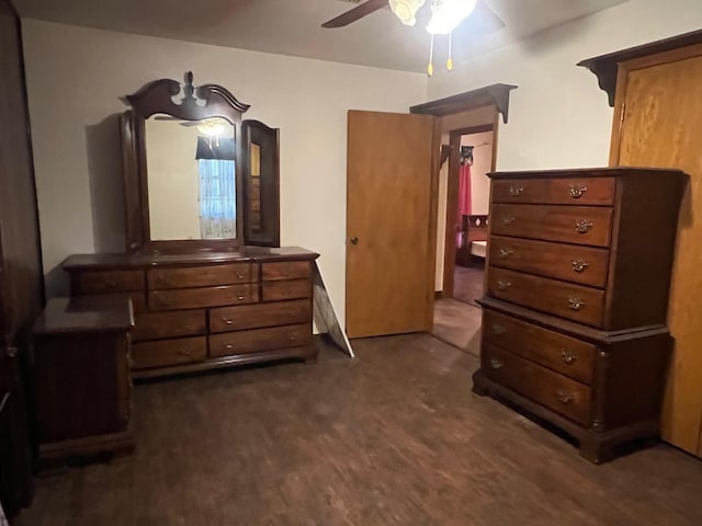 bedroom with dark hardwood / wood-style flooring and ceiling fan