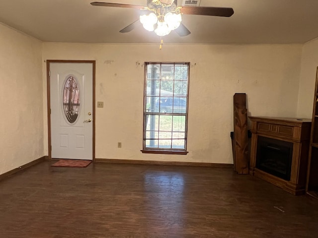 interior space with ceiling fan and dark hardwood / wood-style floors