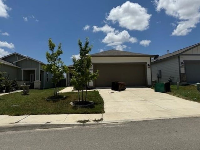 view of front of property with a front lawn and a garage