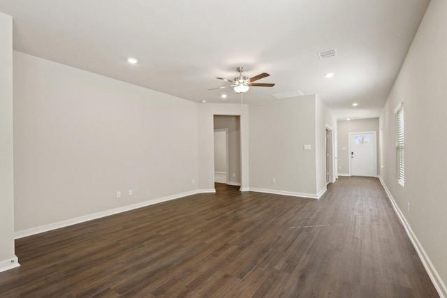 unfurnished room with ceiling fan and dark wood-type flooring