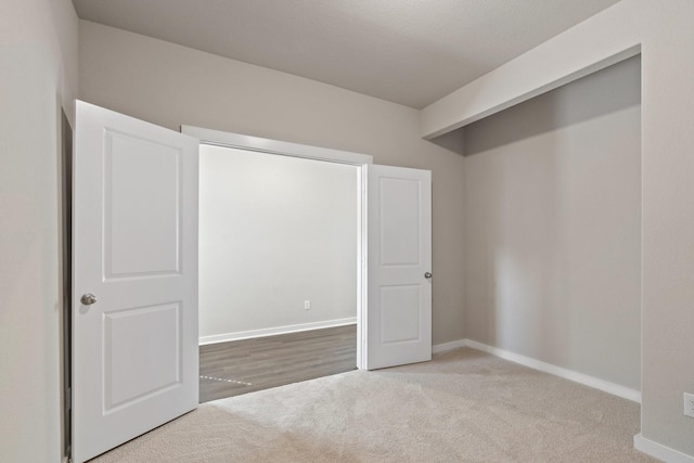 unfurnished bedroom with light colored carpet