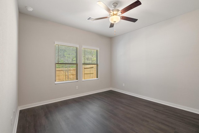 spare room featuring dark hardwood / wood-style flooring and ceiling fan