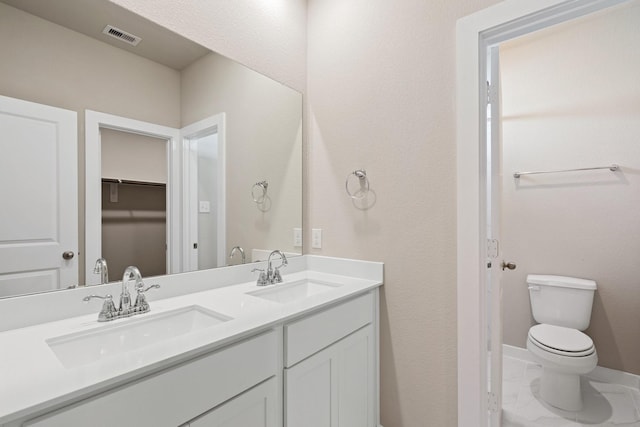 bathroom with toilet and vanity