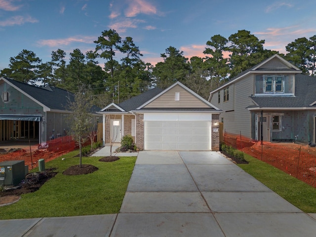 view of front of home featuring a garage and a lawn