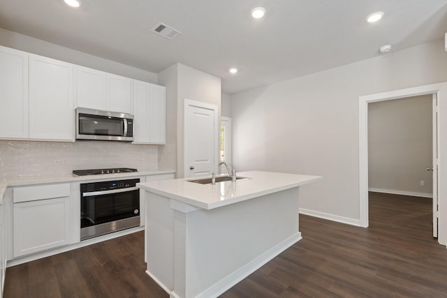 kitchen featuring an island with sink, white cabinetry, stainless steel appliances, and sink