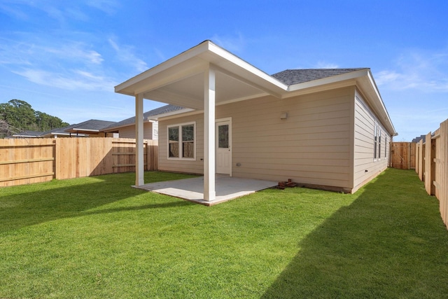 rear view of house featuring a lawn and a patio area