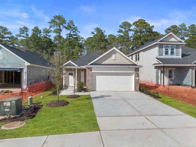 view of front of property featuring a front yard and a garage