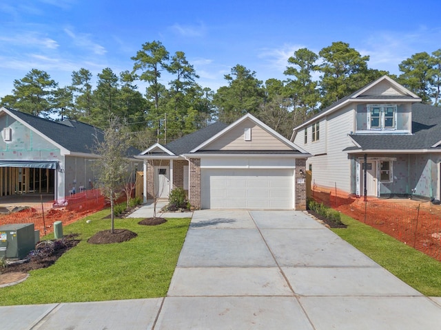 view of front of property featuring a garage and a front lawn