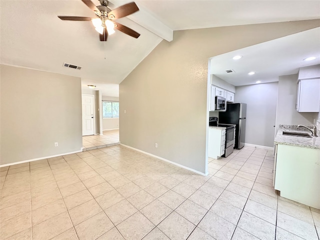 kitchen featuring lofted ceiling with beams, ceiling fan, sink, white cabinetry, and appliances with stainless steel finishes