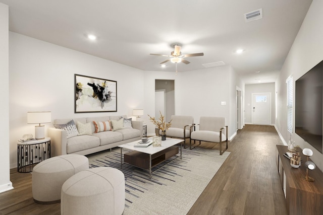 living room featuring dark hardwood / wood-style floors and ceiling fan