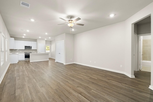 unfurnished living room featuring hardwood / wood-style flooring and ceiling fan