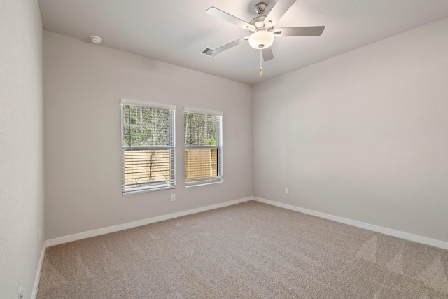 carpeted empty room featuring ceiling fan