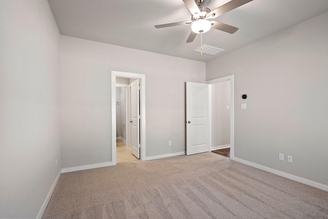 unfurnished bedroom with light carpet, ceiling fan, and ensuite bath