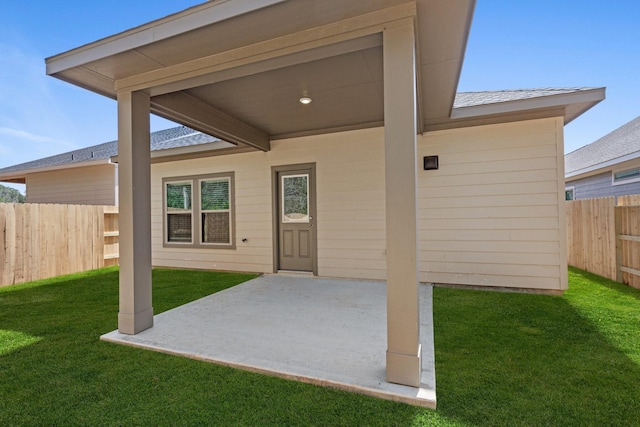 property entrance featuring a patio area and a lawn