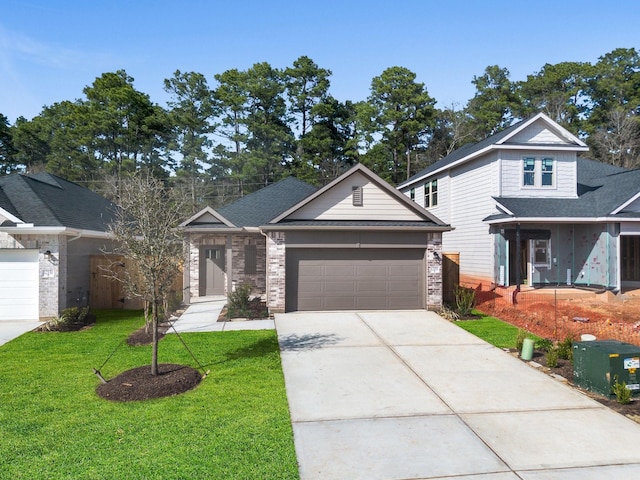 view of front of home with a front yard and a garage