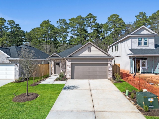 view of front of property featuring a garage and a front lawn